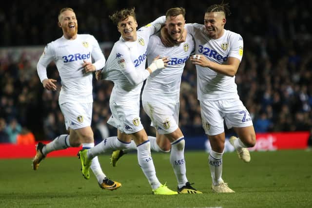 Liam Cooper, in Leeds United's home kit, celebrates his goal against Ipswich Town.