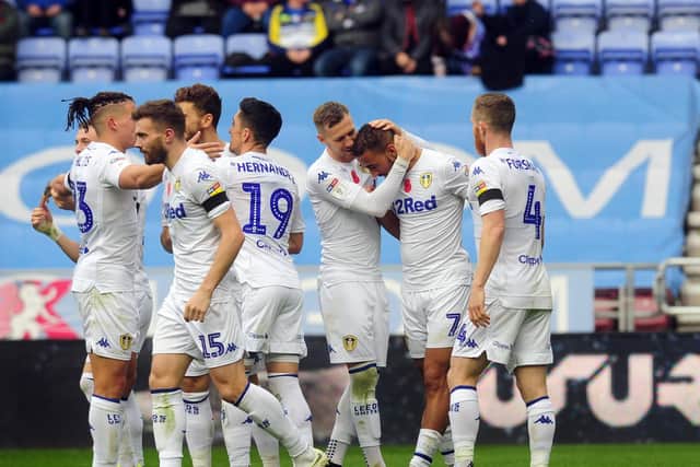 Leeds United's players celebrate with Kemar Roofe after his seventh goal of the season at Wigan Athletic on Sunday. The striker's contract at Elland Road runs until the summer of 2020.
