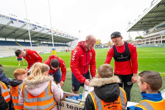 GROWING APPEAL: England's RL players players sign autographs and meet local schoolchildren at Headingley before practice on Wednesday. Picture: Allan McKenzie/SWpix.com
