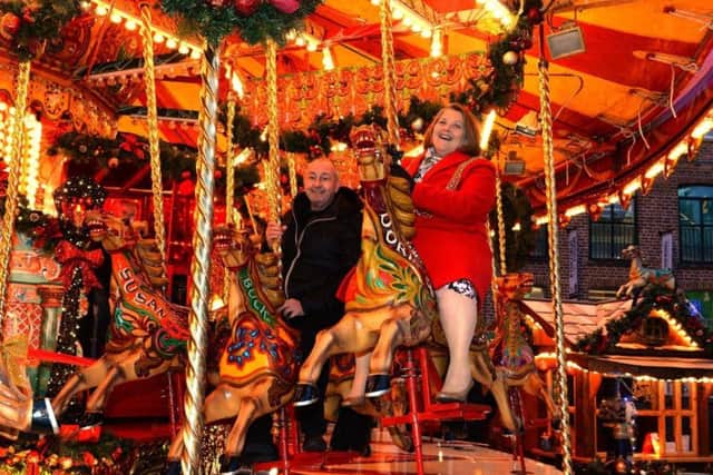 The Lord Mayor of Leeds, Councillor Jane Dowson , enjoying the merry go round with Kurt Stroscher at the Leeds Christmas Market in 2017. Pic by Bruce Rollinson