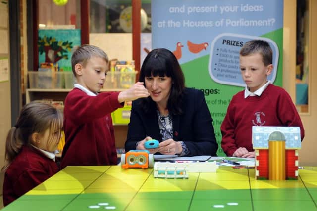 Rachel Reeves MP for Leeds West with children at Lawns Park Primary School in Leeds help programme an agbot  or agricultural robot as part of an event which is being delivered at the school by the National Farmers Unions education team.