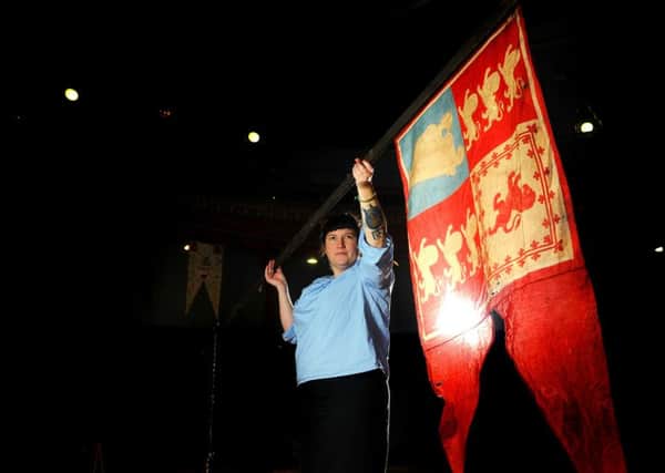 Project curator Lucy Moore with a 100 year old flag at Leeds City Museum used by Leeds teenager Madge Howdill. PIC: Tony Johnson