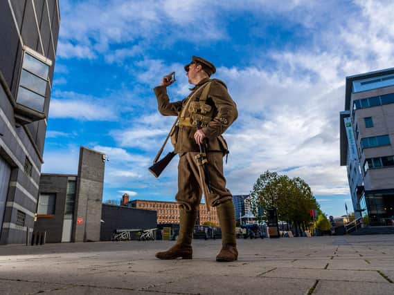 Interpreter Mike Broadley, dressed as a British WW1 soldier, holding a bullet which cost the lives of so many during the conflict.