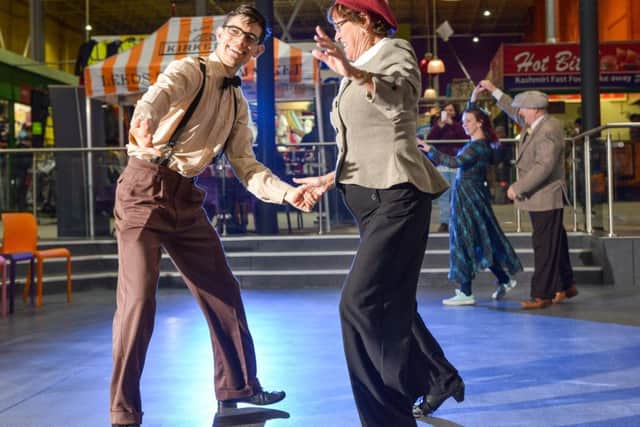 M&S ARCHIVE 1940s Swing Dancers entertain the shoppers in Leeds indoor Market today