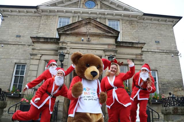 FUNDRAISER: Martin House mascot Marty Bear and Santas launch the Wetherby Santa Run outside Wetherby Town Hall.