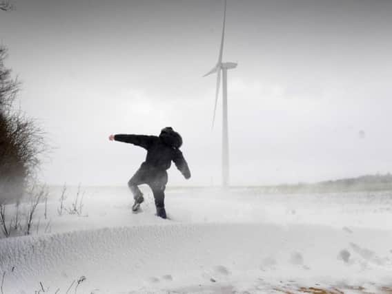 A man walks through snow drifts and blizzard conditions at Hook Moor Wind Farm, near Garforth, Leeds on March 1, 2018. Photo by Simon Hulme