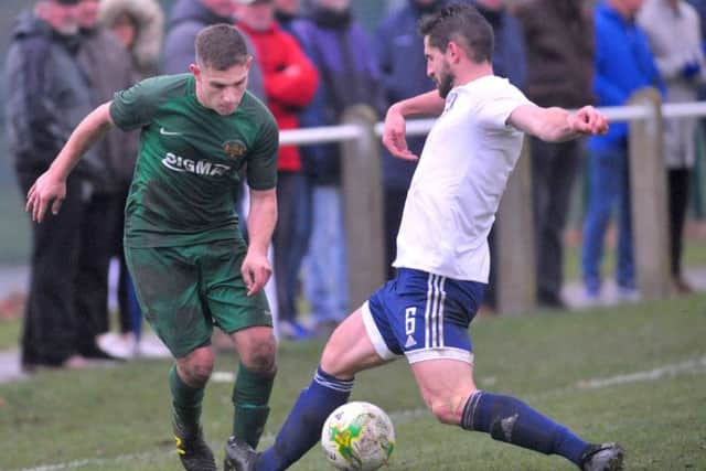 Stephen Crawford, of Beeston, takes on Leeds City's Adam Dutson. PIC: Steve Riding