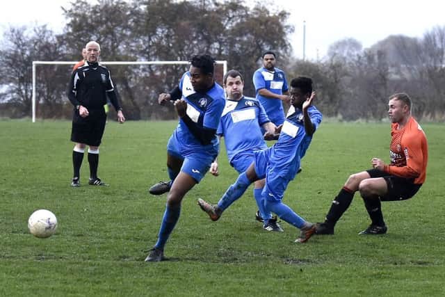 James Tessieman, of Woodkirk, shoots through a packed  Whitkirk Wanderers defence. PIC: Steve Riding