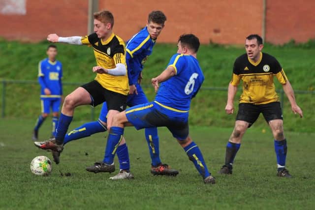Kippax's Harry Pickup in the thick of the action
 against visitors New Armley. PIC: Gerard Binks Photography