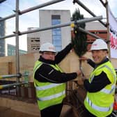Topping out ceremony for the new Maggies Centre, at St James Hospital, Leeds.. John Greenoff (left) and Dr Terry Bramall nail the fern to mark the topping out ceremony.