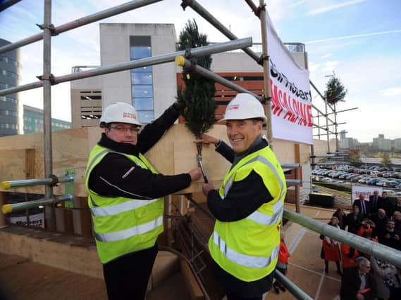 Topping out ceremony for the new Maggies Centre, at St James Hospital, Leeds.. John Greenoff (left) and Dr Terry Bramall nail the fern to mark the topping out ceremony..14th November 2018 ..Picture by Simon Hulme
