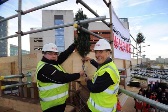 Topping out ceremony for the new Maggies Centre, at St James Hospital, Leeds.. John Greenoff (left) and Dr Terry Bramall nail the fern to mark the topping out ceremony..14th November 2018 ..Picture by Simon Hulme