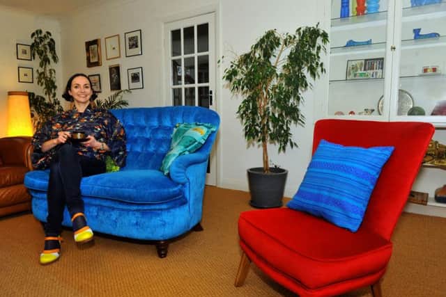 Victoria in the sitting room on the vintage sofa she had recovered in one of her favourite colours.