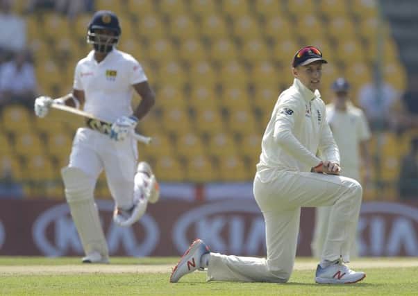 England's captain Joe Root watches as Sri Lanka's Dimuth Karunaratne runs between wickets in Pallekele. Picture: AP/Eranga Jayawardena