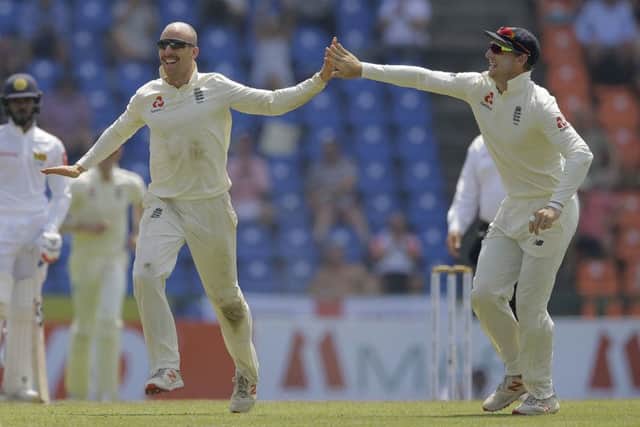 England's Jack Leach, second right, celebrates taking the wicket of Sri Lanka's Kusal Mendis in Pallekele. Picture: AP/Eranga Jayawardena
