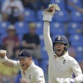 England's wicketkeeper Ben Foakes celebrates taking a catch to dismiss Sri Lanka's Angelo Mathews with Ben Stokes on day two in Pallekelle. Picture: AP/Eranga Jayawardena