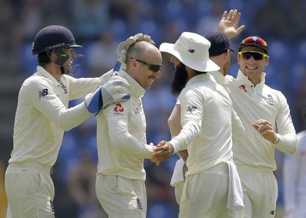 England's Jack Leach, second left, is congratulated by his team mates for taking the wicket of Sri Lanka's Kusal Mendis. Picture: AP/Eranga Jayawardena
