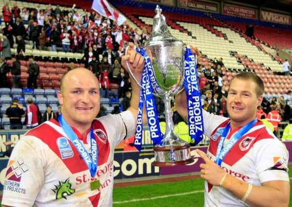 Michael Weyman and Leeds Rhinos' new signing Trent Merrin with the World Club Challenge Trophy in 2011.