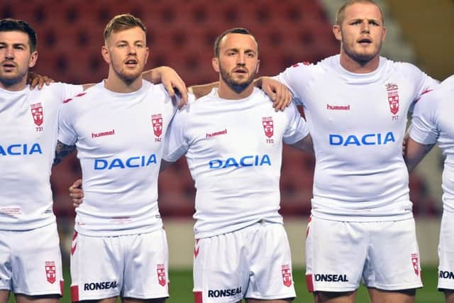 Tom Johnstone lines up with his England team-mates before the France game.