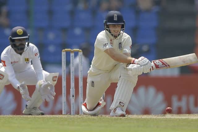 Captain Joe Root, right, plays a reverse sweep on his way to posting a fourth overseas Test century for England, against Sri Lanka in Pallekele. Picture: AP/Eranga Jayawardena