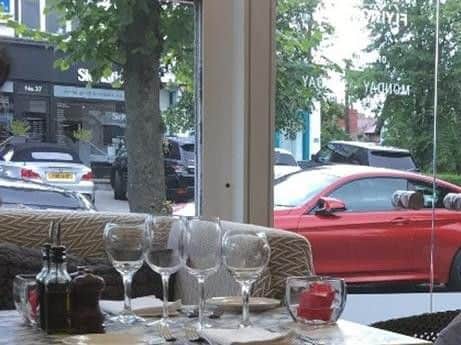 The silver BMW can be seen in the background if this photo taken in the Flying Pizza restaurant.
