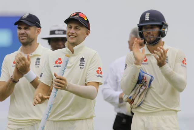 England's captain Joe Root, center, James Anderson, left, and Ben Foakes celebrate their victory over Sri Lanka by 57 runs in Pallekele. Picture: AP/Eranga Jayawardena.