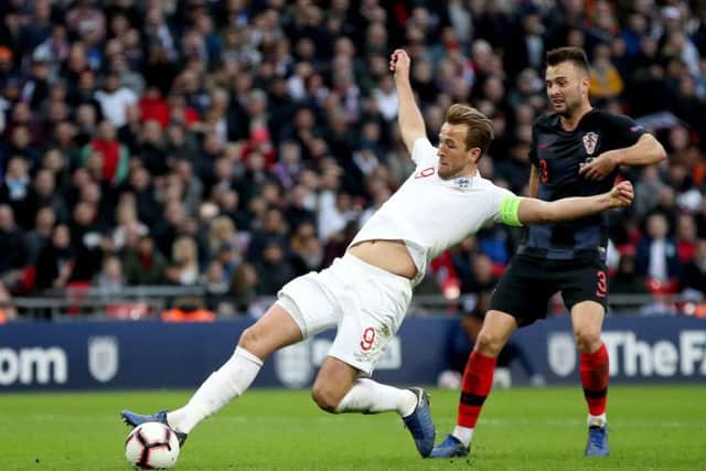 CAPTAIN FANTASTIC: England's Harry Kane (left) scores his side's winning goal at Wembley. Picture: Nick Potts/PA