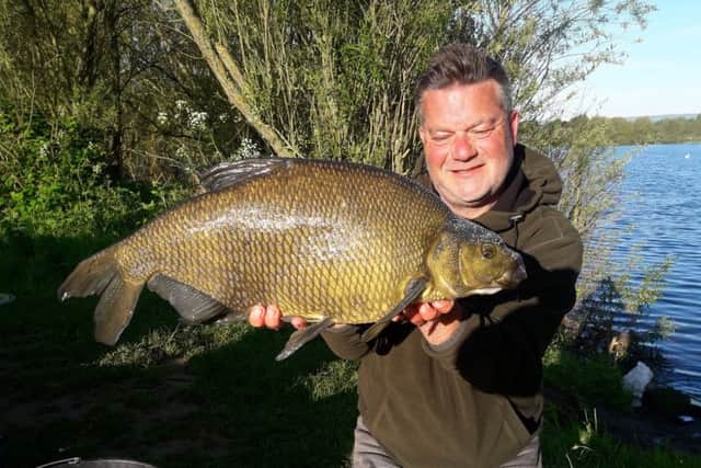 Darren Starkey peeps over the shoulders of a near-12lb Knotford bream. The new keepnet ban should keep these fish in perfect condition.