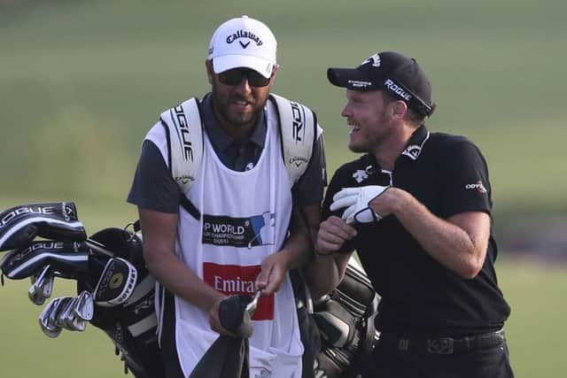 Danny Willett talks with his caddy as they approach the 18th green on Sunday at the DP World Tour Championship in Dubai. Picture: AP/Kamran Jebreili