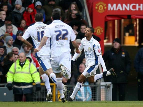 Bradley Johnson and Andrew Hughes sprint to celebrate with Jermaine Beckford after the striker's goal in Leeds United's FA Cup victory over Manchester United at Old Trafford in 2010.