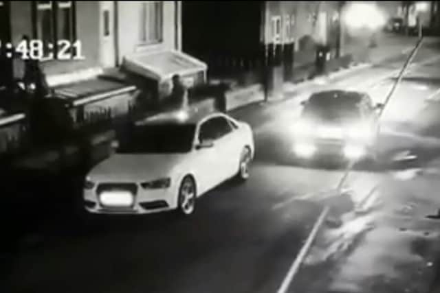 CCTV images show thugs kicking through the door of a residential home in Ravensthorpe.