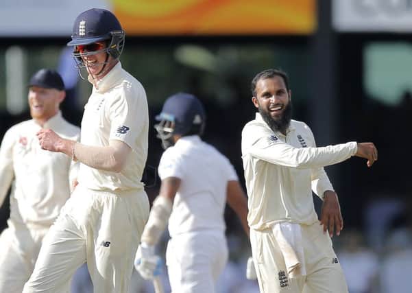 England's fielder Keaton Jennings, front left, along with bowler Adil Rashid, right, celebrate the dismissal of Sri Lanka's Roshen Silva in ColomboAP/Eranga Jayawardena