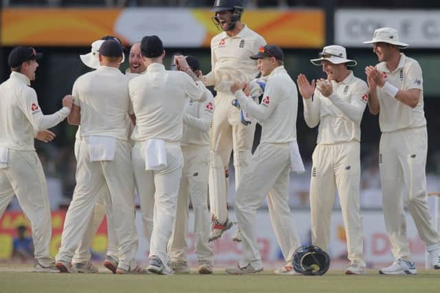 England players celebrate the dismissal of Sri Lanka's Dhananjaya de Silva during the third day of the third test cricket match between Sri Lanka and England in Colombo.