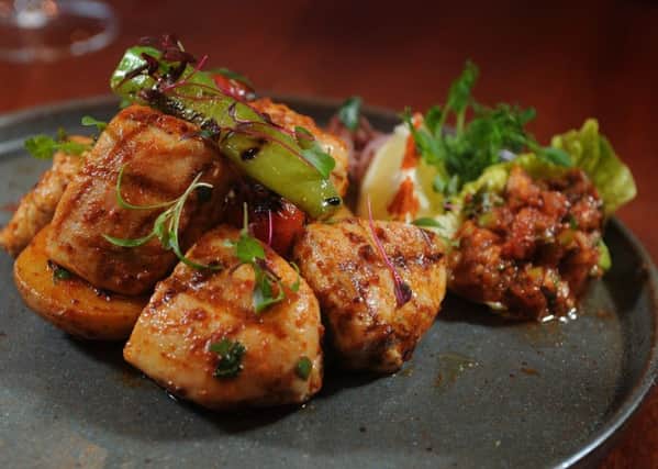 Chicken marinated and cooked the traditional way by being
chargrilled on a brochette. Served with sautÃ©d potato, rice and chilli relish. PIC: Tony Johnson