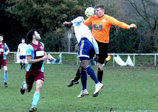 James Burgess, of Leeds City, is beaten to the ball by Rawdon OB goalkeeper Nick Hudson during Saturday's top-flight West Yorkshire League meeting. PIC: Steve Riding