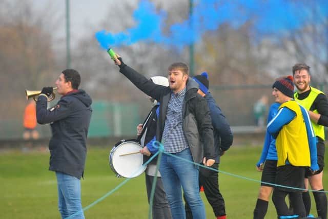 Travelling Howden fans brought a horn, tambourine, drum and flares to show amazing support for their team, who exited the Old Boys' Shield 4-0 to Leeds City OB. PIC: Steve Riding