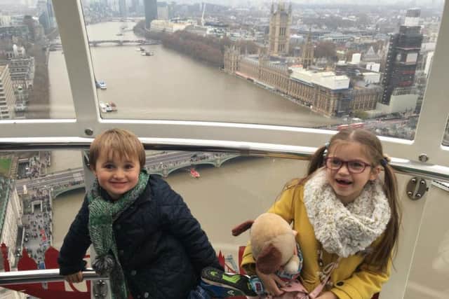 Henry and Maisie taking in the views as they head for the top of London Eye.