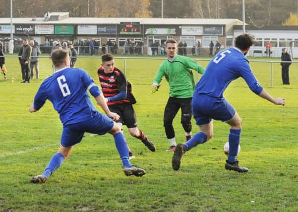Josh Whiteley, of Stanley United, beats  Alwoodley goalkeeper Damian Brodowski but his shot is wide during Saturday's Old Boys' Shield encounter. PIC: Steve Riding