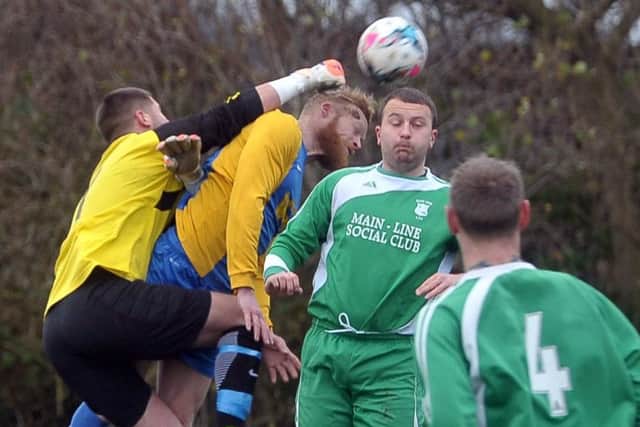 Main Line keeper Gareth Mattison punches clear from Hope's Scott Jones. PIC: Tony Johnson