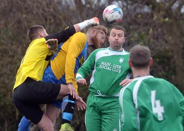 Main Line keeper Gareth Mattison punches clear  from Hope's Scott Jones. PIC: Tony Johnson