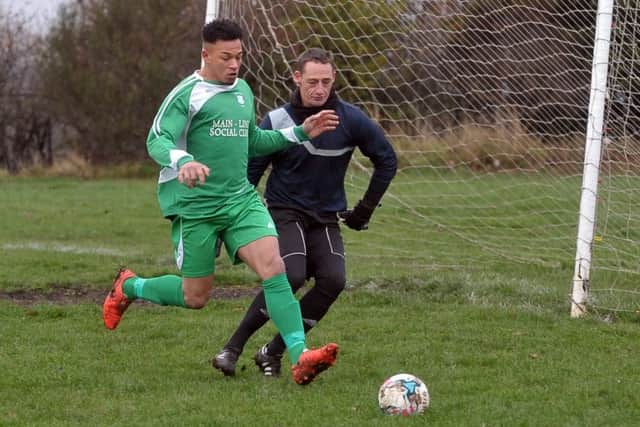 Main Line forward Bradley Francis-White beats Hope's keeper Mark Bower to the ball. PIC: Tony Johnson