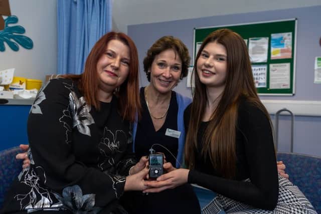 Date:27th November 2018. Picture James Hardisty. Laura Dunion, aged 17, of Oulton, Leeds, is one of only three youngsters in the UK to be given the Medtronic Minimed 670G Hyrid Closed Loop Pump to control her Type 1 Diabetes. Pictured Laura Dunion, with her mum Lynn (left) and  (centre) Fiona Campbell, Consultant Paediatrician, at St James's Hospital, Leeds.