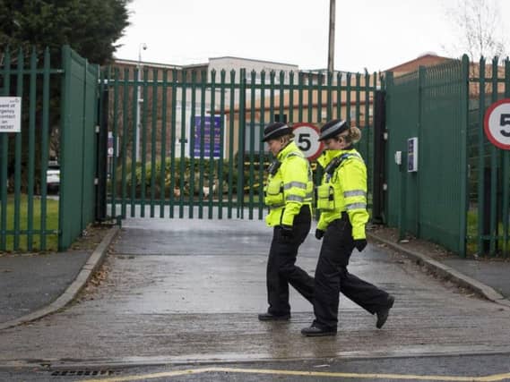 PCSOs walk past Almonbury Community School, where a 15-year-old Syrian refugee was assaulted by another teenager. Picture: PA Wire/Danny Lawson
