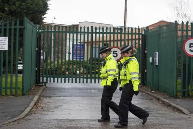 PCSOs walk past Almonbury Community School, where a 15-year-old Syrian refugee was assaulted by another teenager. Picture: PA Wire/Danny Lawson