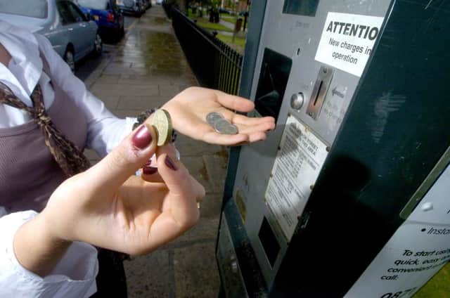 Date:25th June 2008.
Parking Charges increase in Leeds, pictured a motorist putting money into a meter on Park Square North, Leeds.