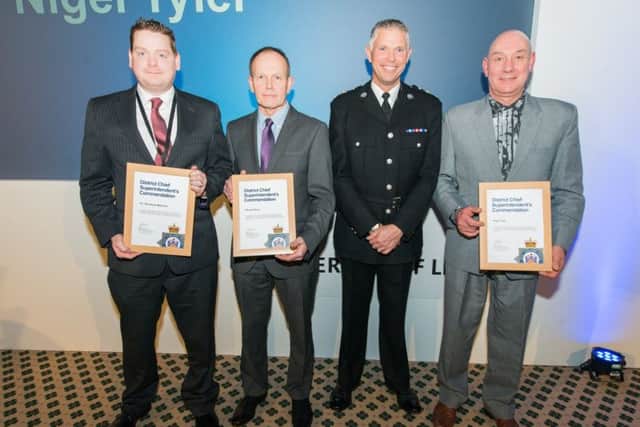 PC Daniel Mahoney, Michael Dunn and Nigel Tyler receive their certificates from Chf Supt Steve Cotter.