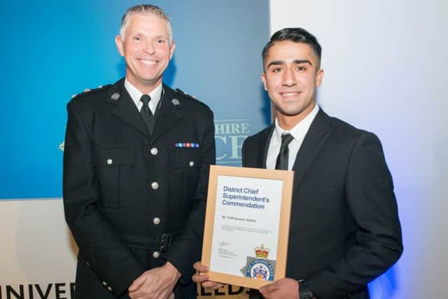 Chf Supt Steve Cotter presents Special Constable Usmaan Akhtar with his award.
