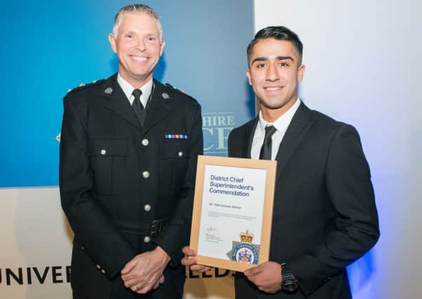 Chf Supt Steve Cotter presents Special Constable Usmaan Akhtar with his award.