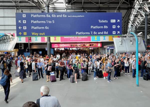 Passengers at Leeds station await information on late trains.