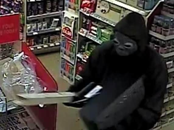One of the robbers was wearing a Halloween mask and wielding a piece of wood.
